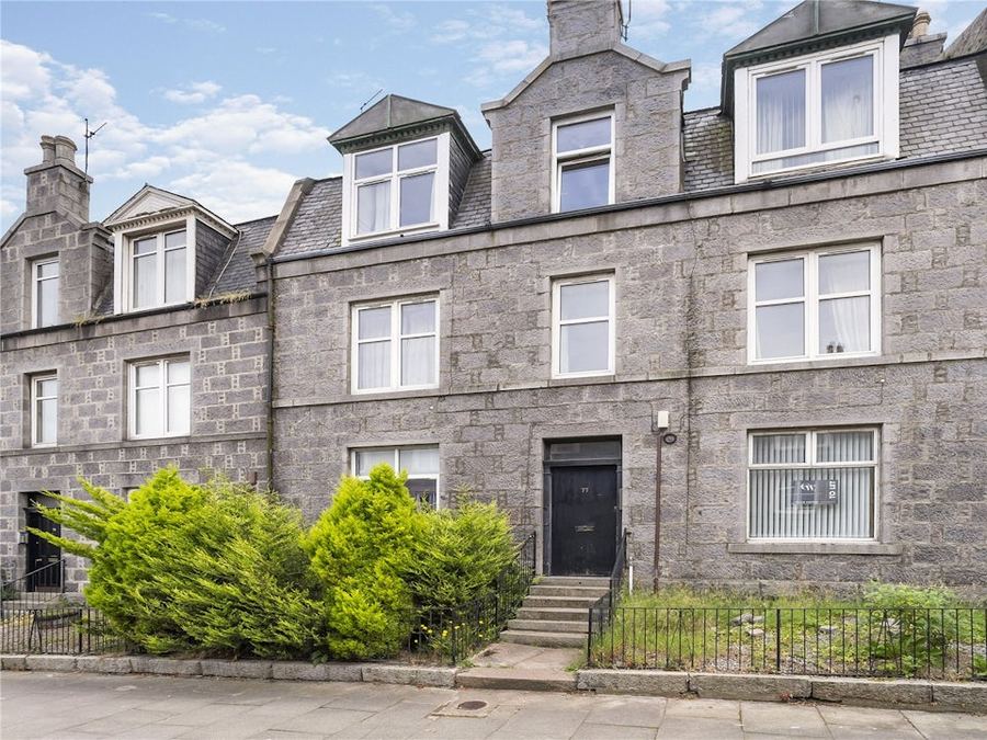 A stone townhouse with a black front door — a current Simpson & Marwick city listing