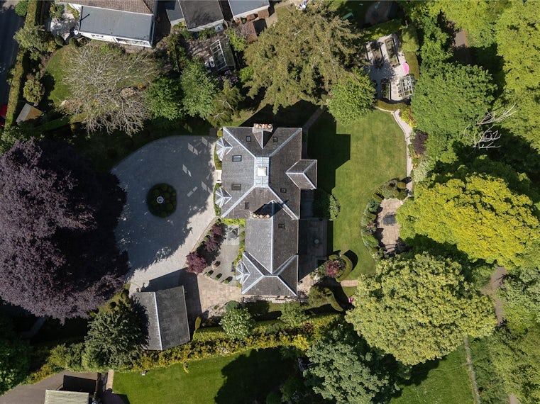 Aerial view of a country house and its gardens, a current Simpson & Marwick rural listing